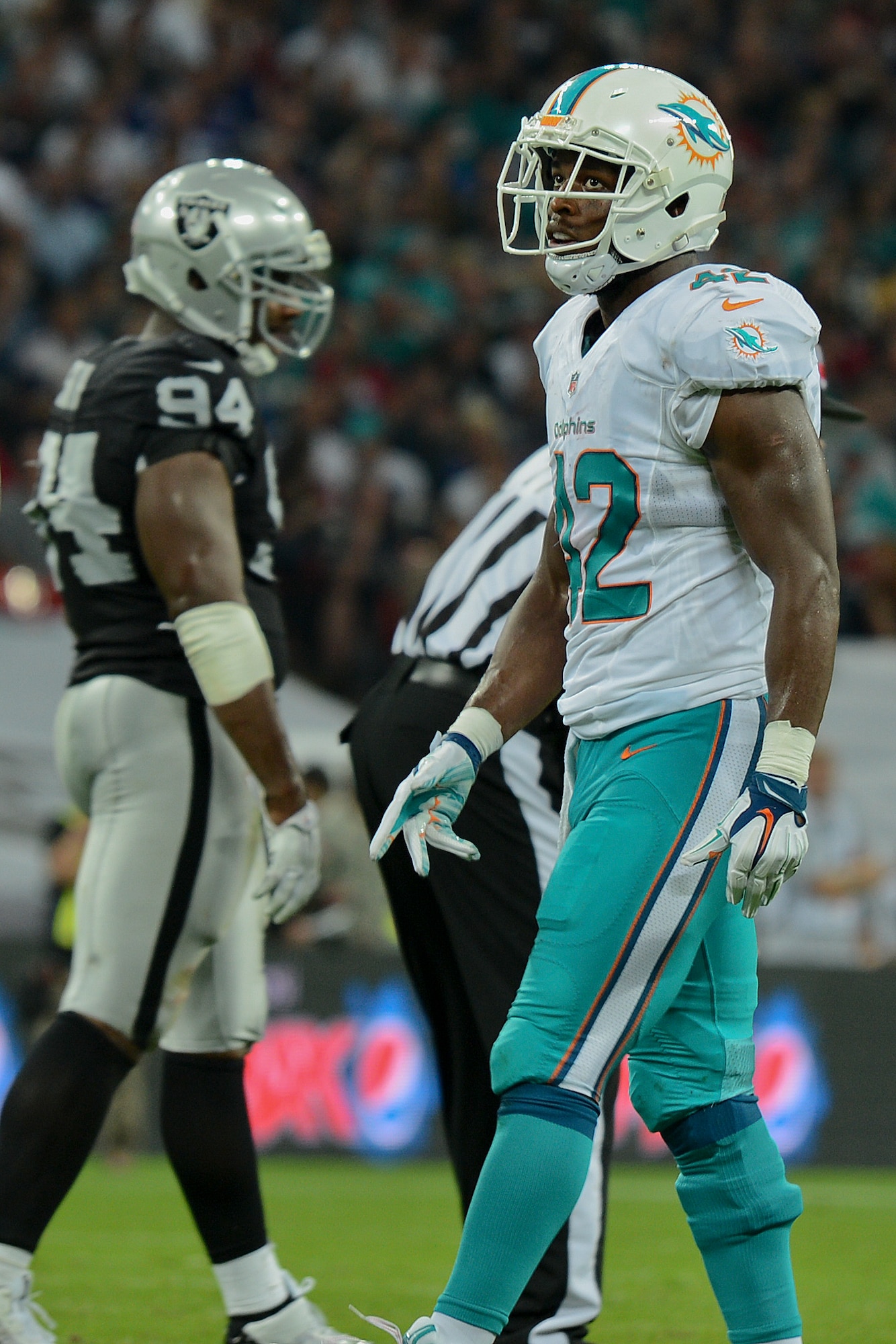 Charles Clay (42), Miami Dolphins tight end, walks off the field after a play during the Miami Dolphins – Oakland Raiders football game in London on Sept. 28, 2014. Clay recorded two receptions for 32 yards in their 38-14 win over the Oakland Raiders. Clay says he has high praise for troops overseas. “They are the reason we have the opportunity to play this game. We have so much respect for those men and women.” (U.S. Air Force photo by Airman 1st Class Trevor T. McBride)