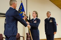 Col. Kathryn Pfeifer, former director of staff for Headquarters, Kentucky Air National Guard, assumes command of the 123rd Mission Support Group as she accepts the unit’s guidon from Col. Barry Gorter, commander of the 123rd Airlift Wing, during a change-of-command ceremony held at the Kentucky Air National Guard Base in Louisville, Ky., Aug 9, 2014. Pfeifer replaces Lt. Col. Matthew Stone (right), who is the new director of staff at Headquarters, Kentucky Air National Guard. (U.S. Air National Guard photo by Senior Airman Joshua Horton)