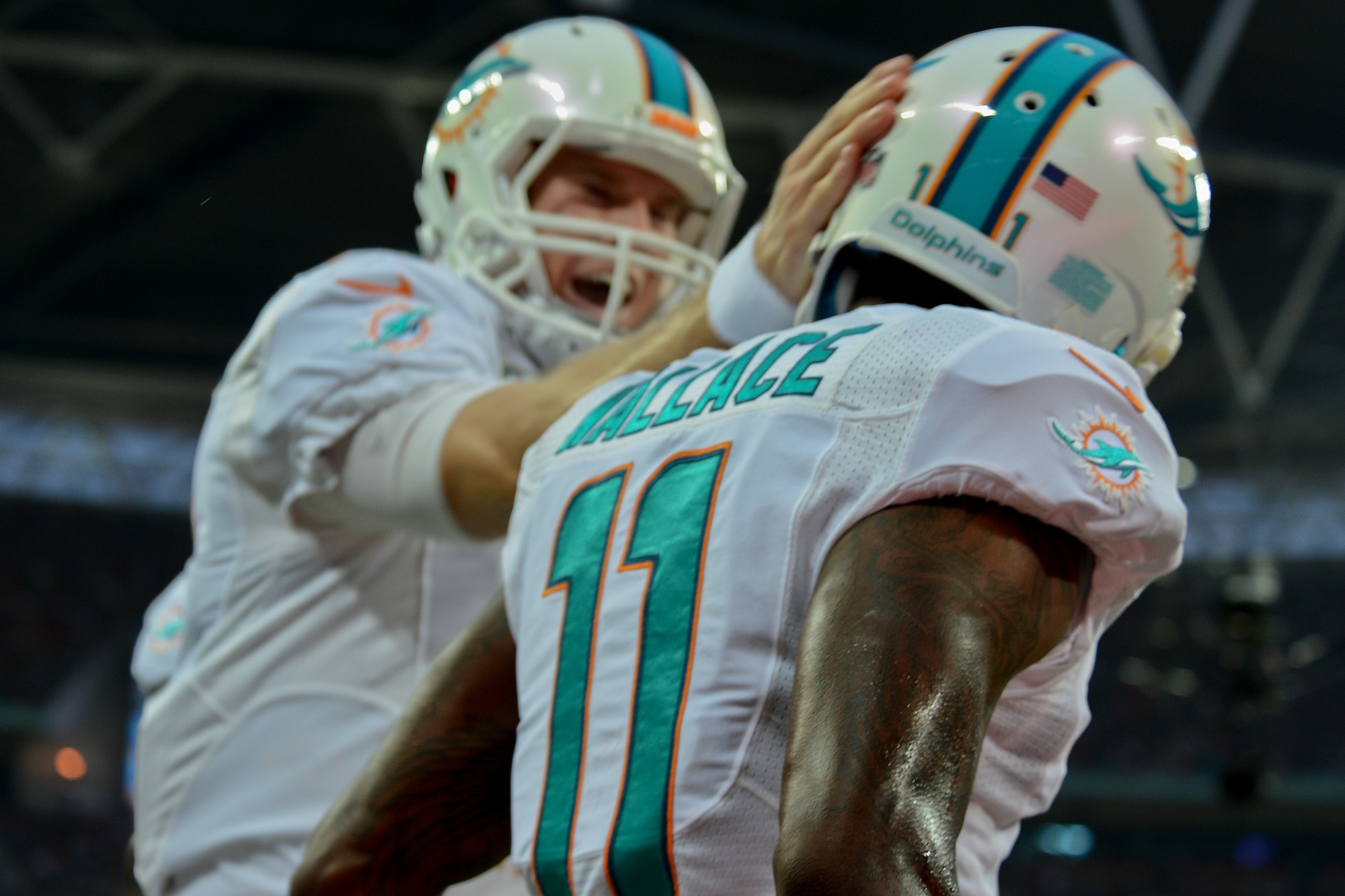 Mike Wallace (11), Miami Dolphins receiver, celebrates with Ryan Tannehill, Dolphins quarterback, after catching a touchdown pass during the Miami Dolphins – Oakland Raiders football game in London on Sept. 28, 2014. Wallace recorded three catches for 35 yards and three touchdowns in their 38-14 win over the Oakland Raiders. (U.S. Air Force photo by Airman 1st Class Trevor T. McBride)