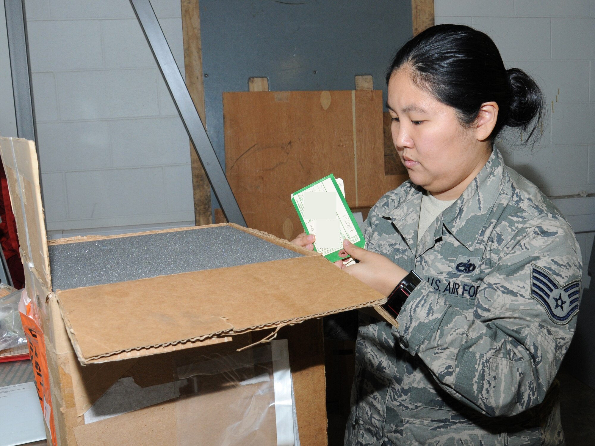 U.S. Air Force Staff Sgt. Erica Northam, 100th Aircraft Maintenance Squadron debrief and supply focal point technician from Juneau, Alaska, verifies turn-in tags for the 100th Logistics Readiness Squadron and ensures they’re back in the supply system Sept. 12, 2014, on RAF Mildenhall, England. Northam ensured the tag matches the part in the box. (U.S. Air Force photo/Gina Randall/Released) 