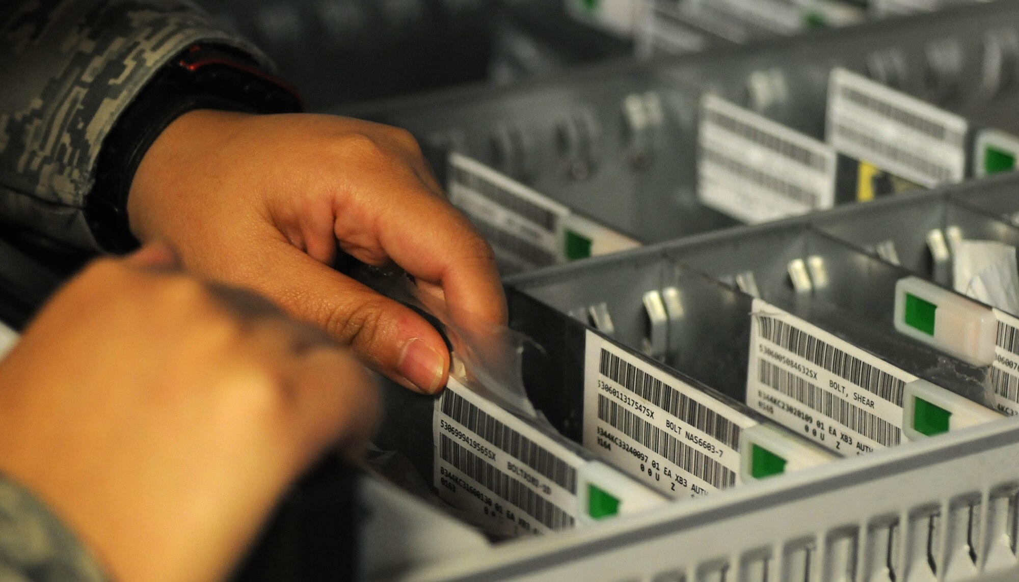 U.S. Air Force Staff Sgt. Erica Northam, 100th Aircraft Maintenance Squadron debrief and supply focal point technician from Juneau, Alaska, inventories bench stock items Sept. 12, 2014, on RAF Mildenhall, England. Any items with red tags means stock needs to be ordered while green tags mean there is sufficient stock at that time. (U.S. Air Force photo/Gina Randall/Released)