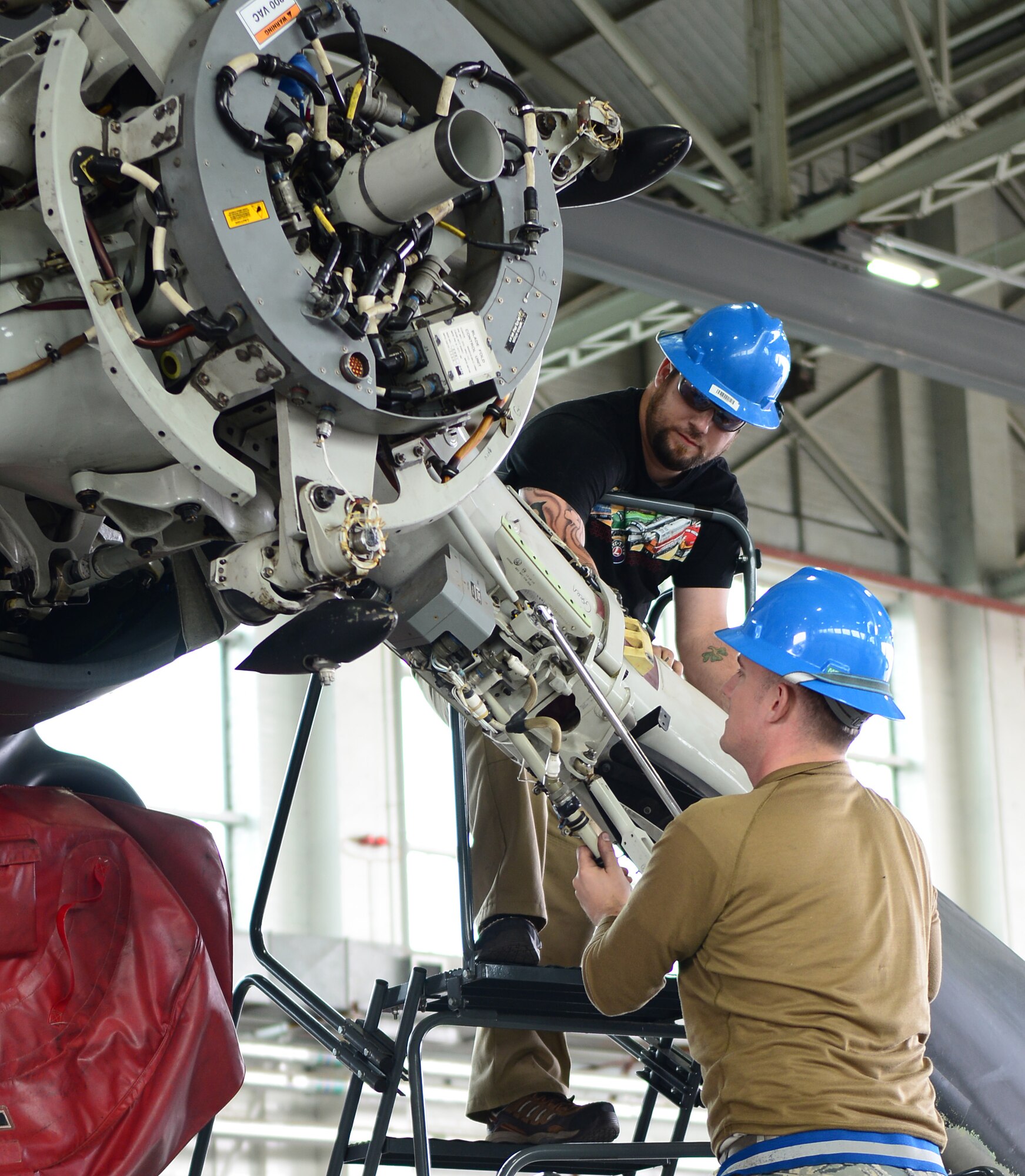 U.S. Air Force Staff Sgt. Jason Jones, right, 352nd Special Operations Maintenance Squadron crew chief from Norco, Calif., and Steve Harrel, 352nd SOMXS contract maintenance support from Middlebury, Ind., remove a blade off a CV-22B Osprey Sept. 23, 2014, on RAF Mildenhall, England. The blade was removed from one CV-22B to improve the ice protection system on another. It was also repainted as preventative maintenance while it was removed. (U.S. Air Force photo/Airman 1st Class Jonathan Light/Released)