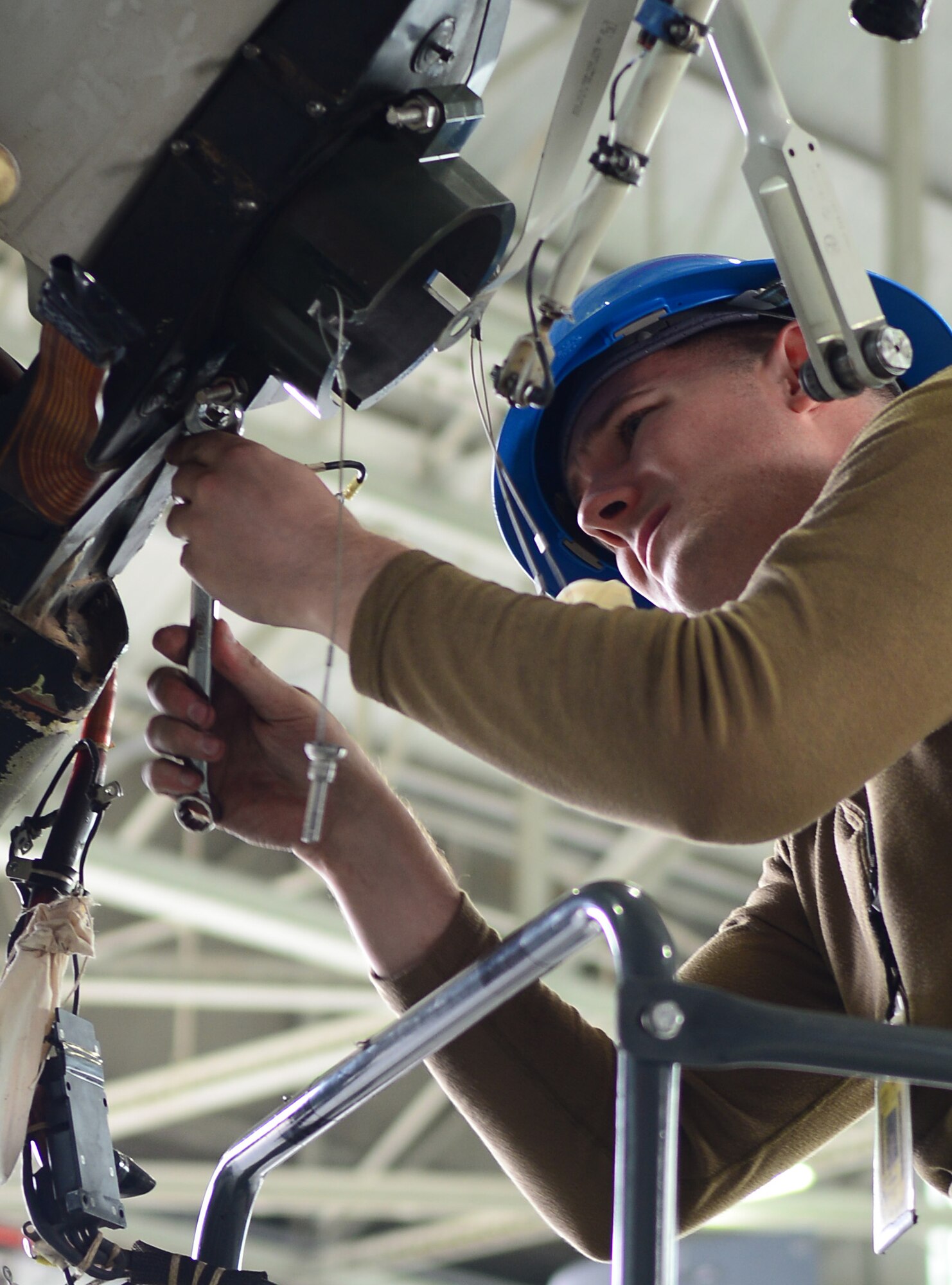 U.S. Air Force Staff Sgt. Jason Jones, 352nd Special Operations Maintenance Squadron crew chief from Norco, Calif., installs part of the blade bolt removal tool on a CV-22B Osprey Sept. 23, 2014, on RAF Mildenhall, England. The blade was removed from one CV-22B to improve the ice protection system on another. It was also repainted as preventative maintenance while it was removed. (U.S. Air Force photo/Airman 1st Class Jonathan Light/Released)