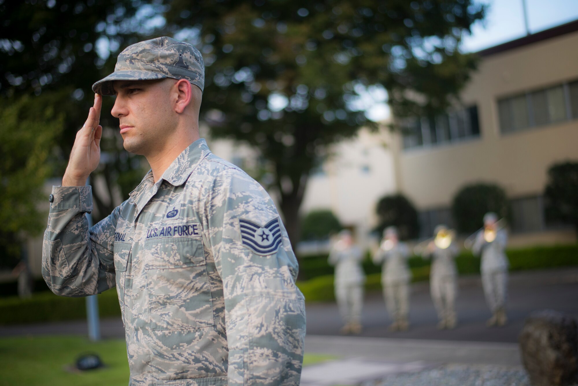 Tech. Sgt. Justin Bernal, 374th Force Support Squadron NCO in charge of installation personnel readiness, salutes during a retreat ceremony at Yokota Air Base, Japan, Sept. 26, 2014. The retreat ceremony serves a twofold purpose. It signals the end of the official duty day as well as a ceremony for paying respect to the flag. (U.S. Air Force photo by Staff Sgt. Chad C. Strohmeyer)(Released)