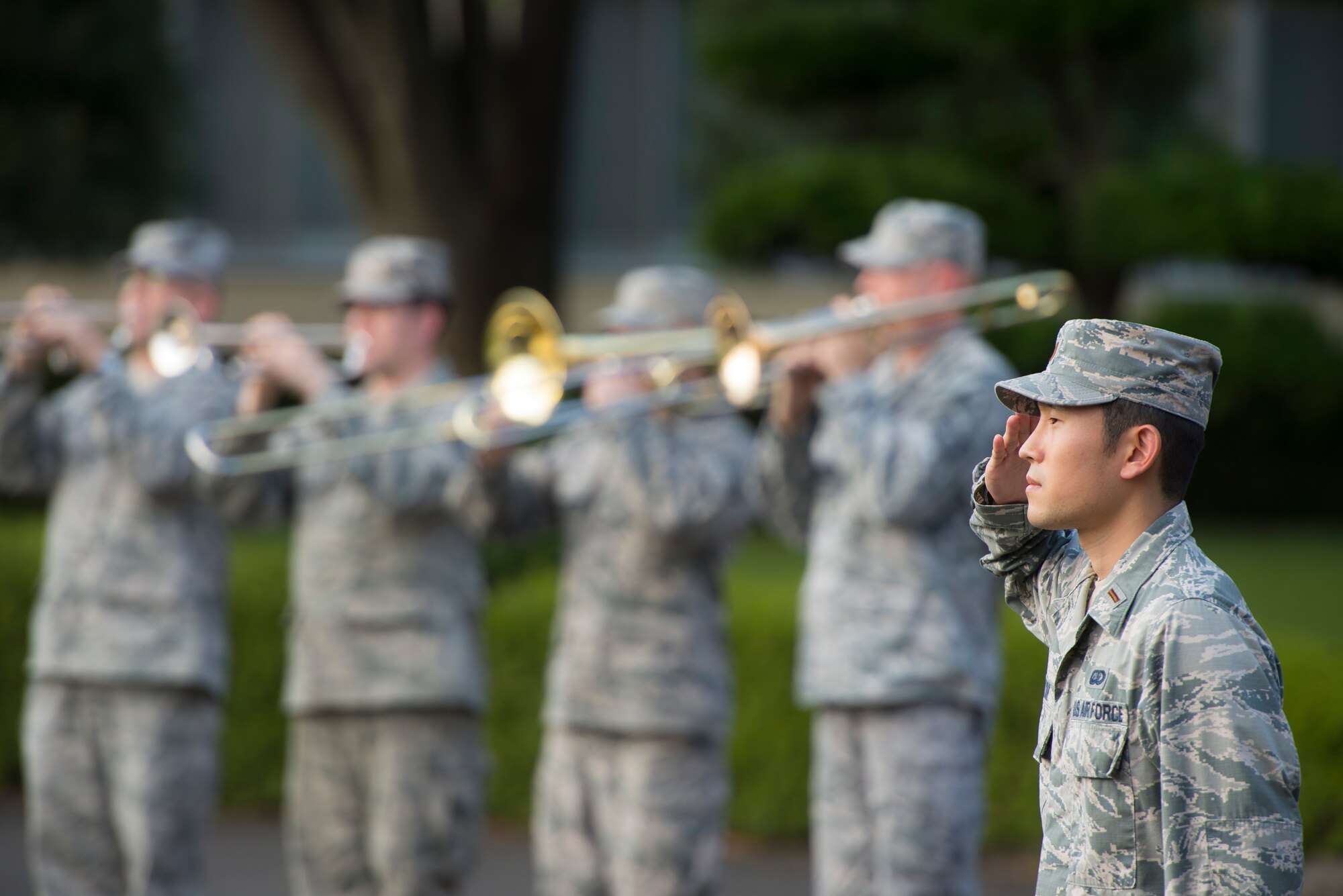 2nd Lt. David Kim, 374th Force Support Squadron chief of military personnel, salutes during a retreat ceremony at Yokota Air Base, Japan, Sept. 26, 2014. The retreat ceremony serves a twofold purpose. It signals the end of the official duty day as well as a ceremony for paying respect to the flag. (U.S. Air Force photo by Staff Sgt. Chad C. Strohmeyer)(Released)