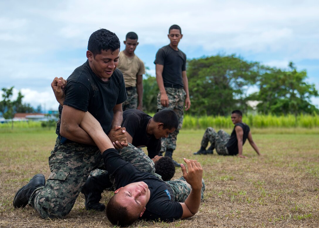 Honduran troops practice the U.S. Marine Corps martial arts program during combat conditioning exchanges with U.S. Marines during Southern Partnership Station 2014 in Puerto Castilla, Honduras, Sept. 24, 2014. The Marines are the Landing Attack Subsequent Operations team.