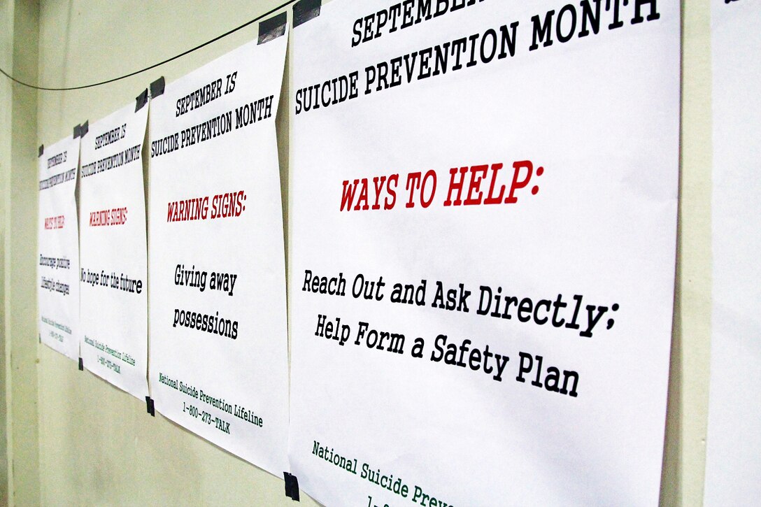Information about the warning signs that someone may attempt suicide and ways to intervene is displayed on the walls of the gym on Camp Murray, Wash., Sept. 26, 2014, as the Washington National Guard held a suicide prevention awareness run.