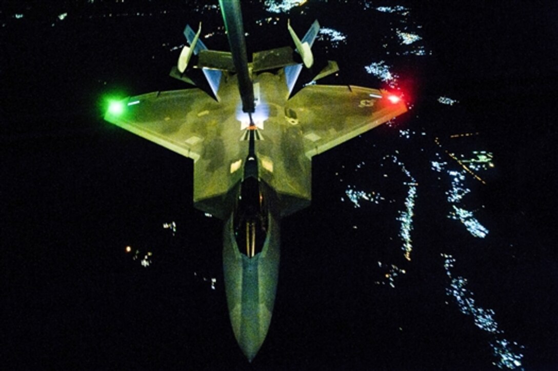 An U.S Air Force KC-10 Extender refuels an F-22 Raptor fighter aircraft before strike operations in Syria, Sept. 26, 2014. These aircraft were part of a strike package engaging targets against the Islamic State of Iraq and the Levant. 