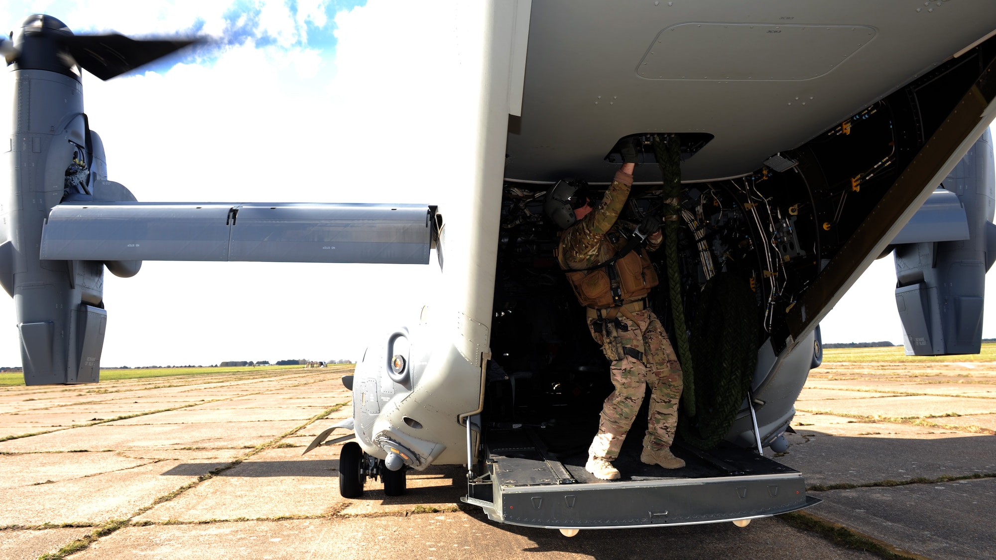 U.S. Air Force Senior Master Sgt. Erik Davis, 7th Special Operations Squadron CV-22B Osprey special mission aviator, connects the heavy rope prior to the Special Tactics Airmen who will infiltrate an area during training using the Fast Rope Insertion Extraction System, March 25, 2015, at RAF Sculthorpe in Norfolk, England. (U.S. Air Force photo by Tech. Sgt. Stacia Zachary)