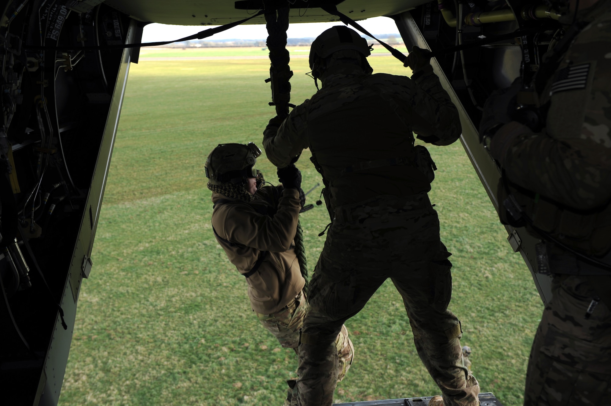 U.S. Air Force Senior Master Sgt. Erik Davis, 7th Special Operations Squadron CV-22B Osprey special mission aviator, steadies the Novabraid fast rope as a Special Tactics Airman infiltrates an area during training using the Fast Rope Insertion Extraction System, March 25, 2015, at RAF Sculthorpe in Norfolk, England. (U.S. Air Force photo by Tech. Sgt. Stacia Zachary)