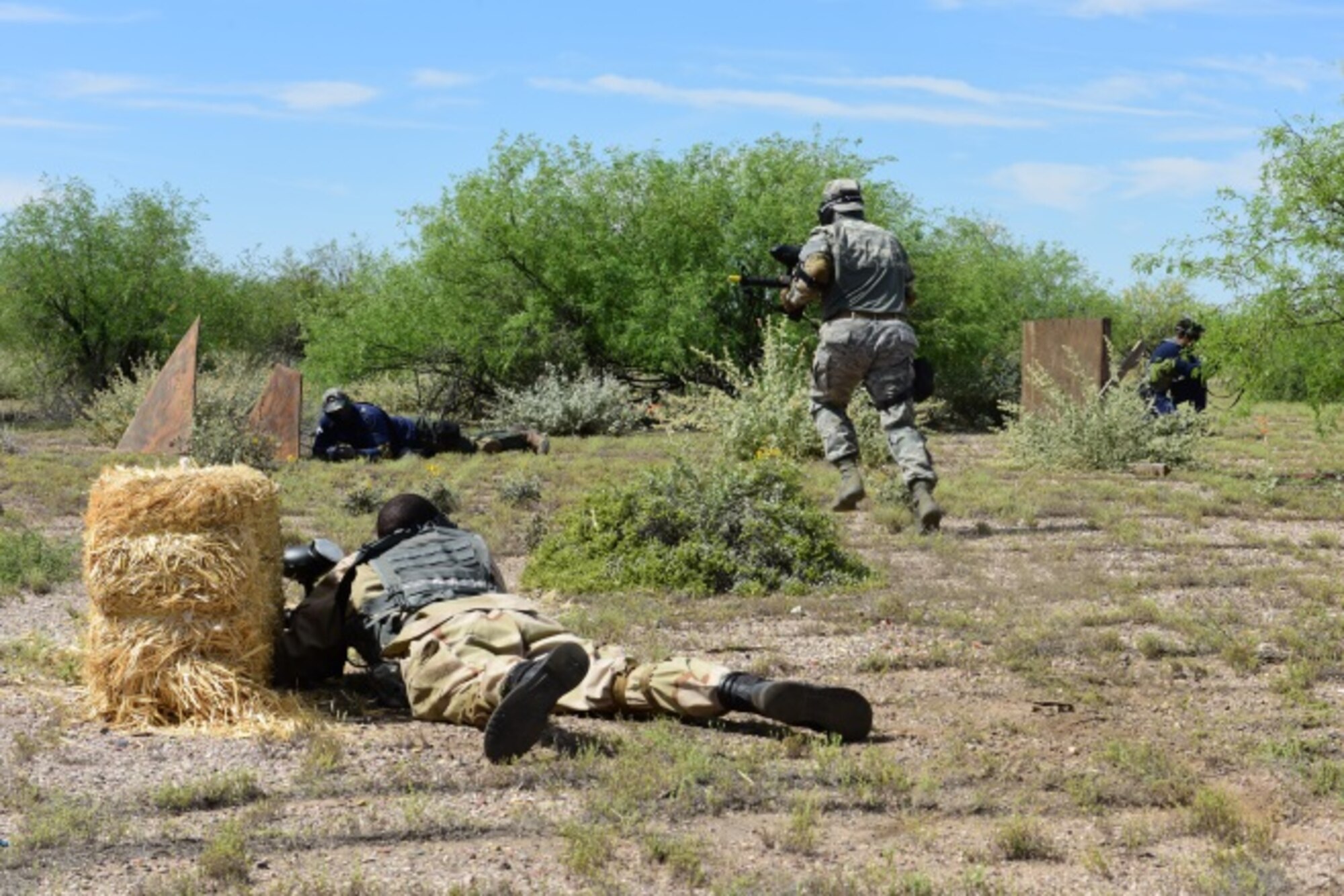 Tactical Combat Casualty Care students suppress fire during a field training exercise March 26 at the Luke Auxiliary Field. The class was taught by the 944th Aeromedical Staging Squadron to Luke reservist and members of the Scottsdale Fire Department and SWAT Team. (U.S. Air Force photo by Staff Sgt. Lausanne Kinder)
