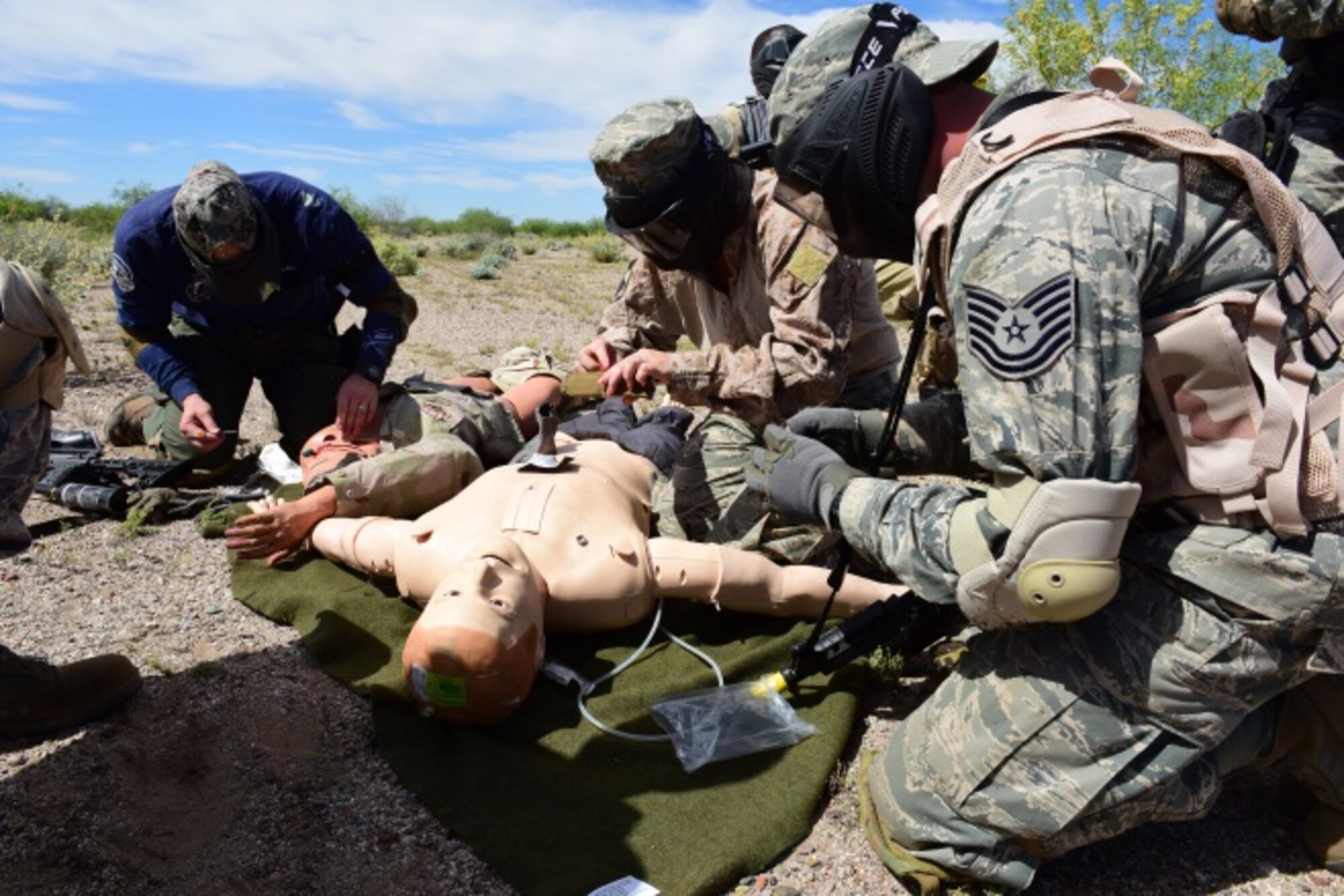 Tactical Combat Casualty Care students provide treatment to a simulated wounded patient during a field training exercise March 26 at the Luke Auxiliary Field. The class was taught by the 944th Aeromedical Staging Squadron to Luke reservist and members of the Scottsdale Fire Department and SWAT Team. (U.S. Air Force photo by Staff Sgt. Lausanne Kinder)
