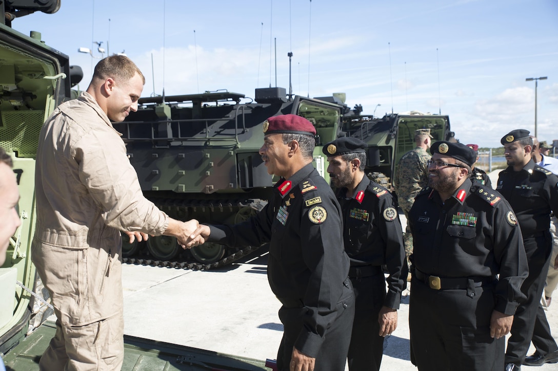 Saudi Arabian Marine Corps officers meet  with Cpl. Robert Loeffler, the assistance maintenance chief at Marine Corps Training Center in Tampa, Fla., Dec. 5, 2014. The Saudi Arabian Marine Corps officers visited Marines with 4th AA Bn. to attend a demonstration about the capabilities of amphibian assault vehicles.