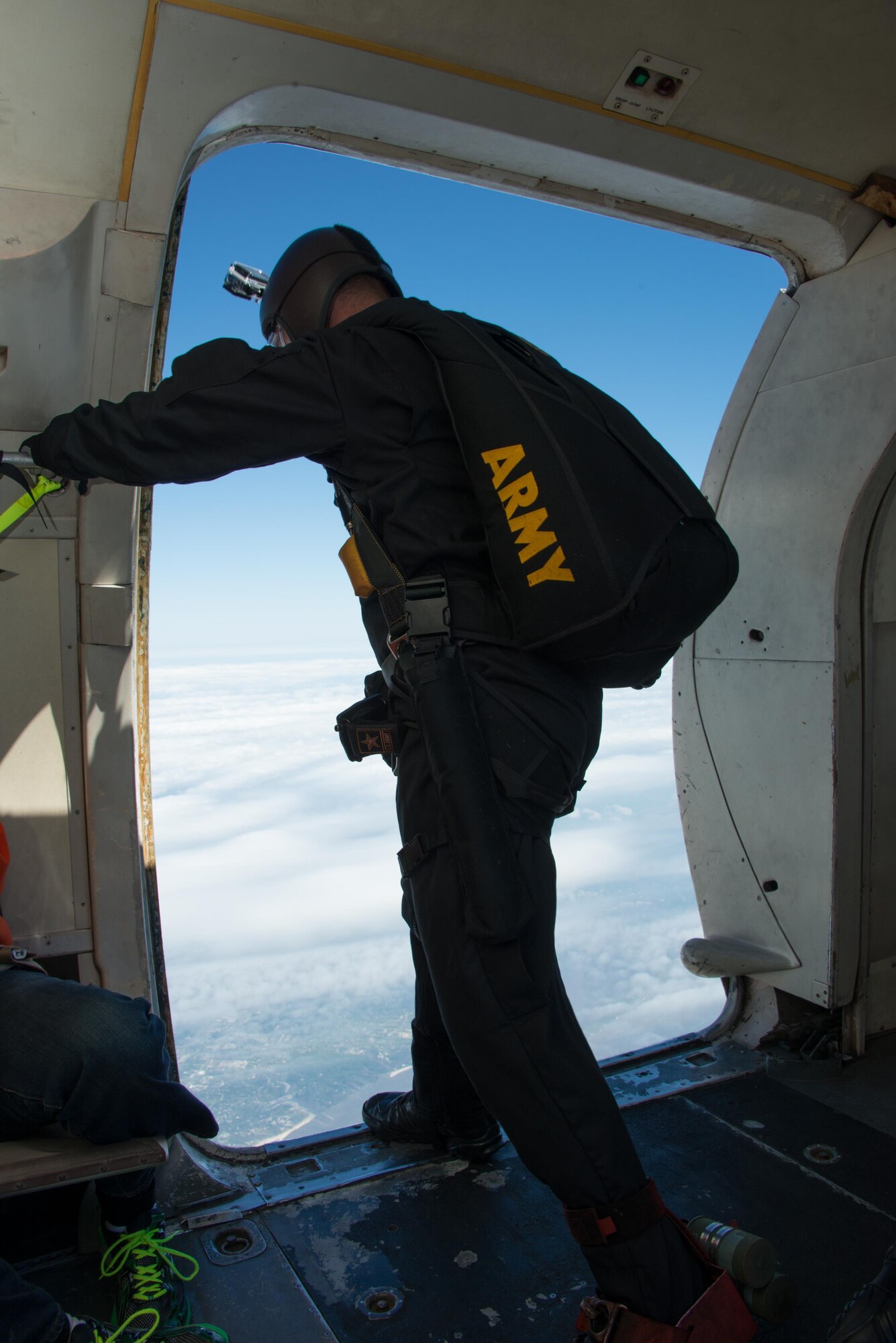 Army Sergeant First Class Corey Hood, a member of the U.S. Army Golden Knights parachute team, prepares to jump from a C-31A at over 12, 500 feet during opening ceremonies for the Keesler Air Force Base, Mississippi Air Show/Open House, March 29, 2015. Approximately 155,000 people were in attendance for the two-day show. (U.S. Air Force photo by Marie Floyd)