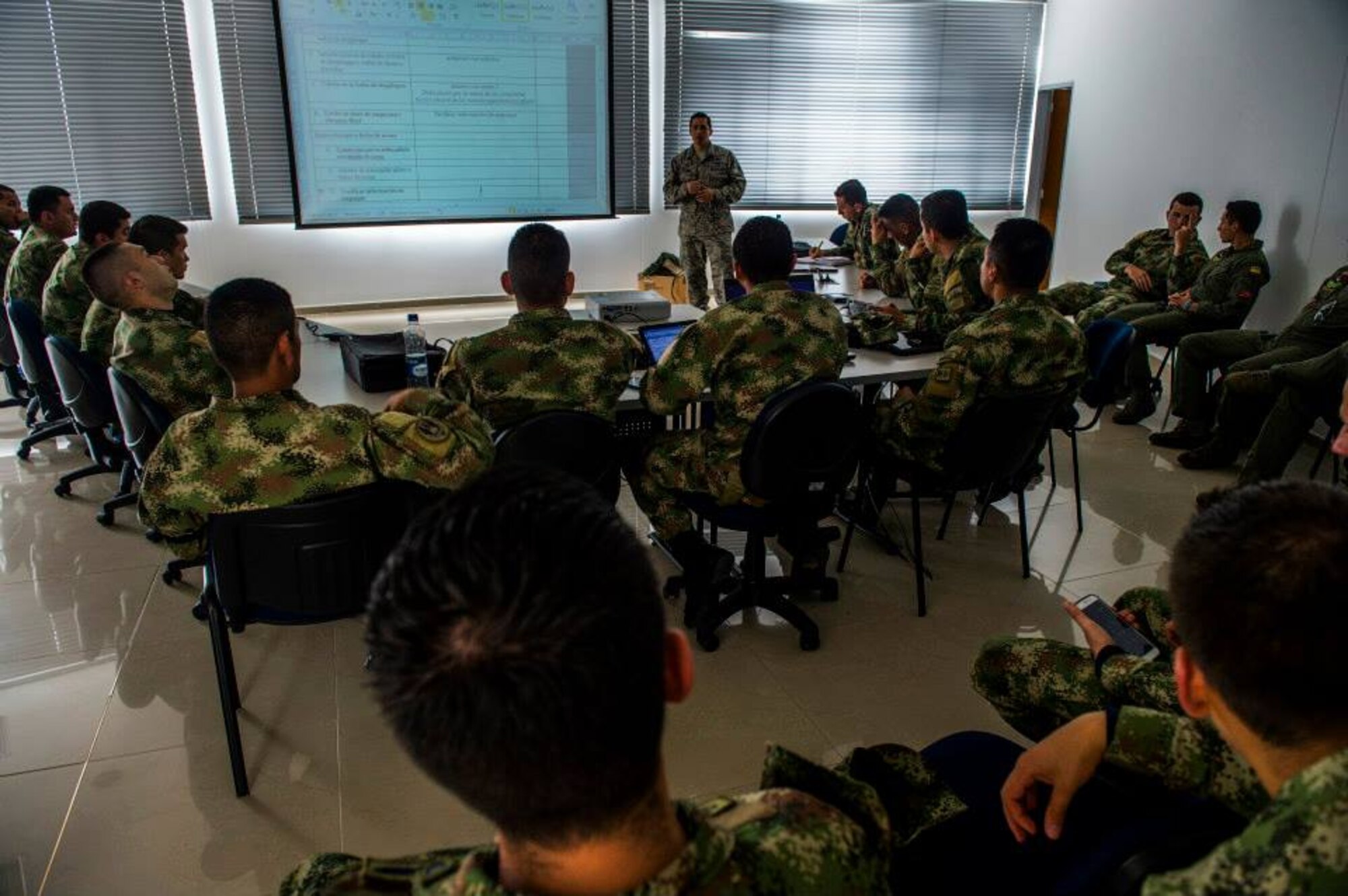 U.S. Air Force Staff Sgt. Peter Salinas assists Colombian airmen in preparation for the first airdrop with U.S. Airmen March 2, 2015, at CATAM airfield in Colombia. Salinas is an aerial porter senior air advisor assigned to the 571st Mobility Support Advisory Squadron. (U.S. Air Force photo/Tech. Sgt. Matthew Hannen)