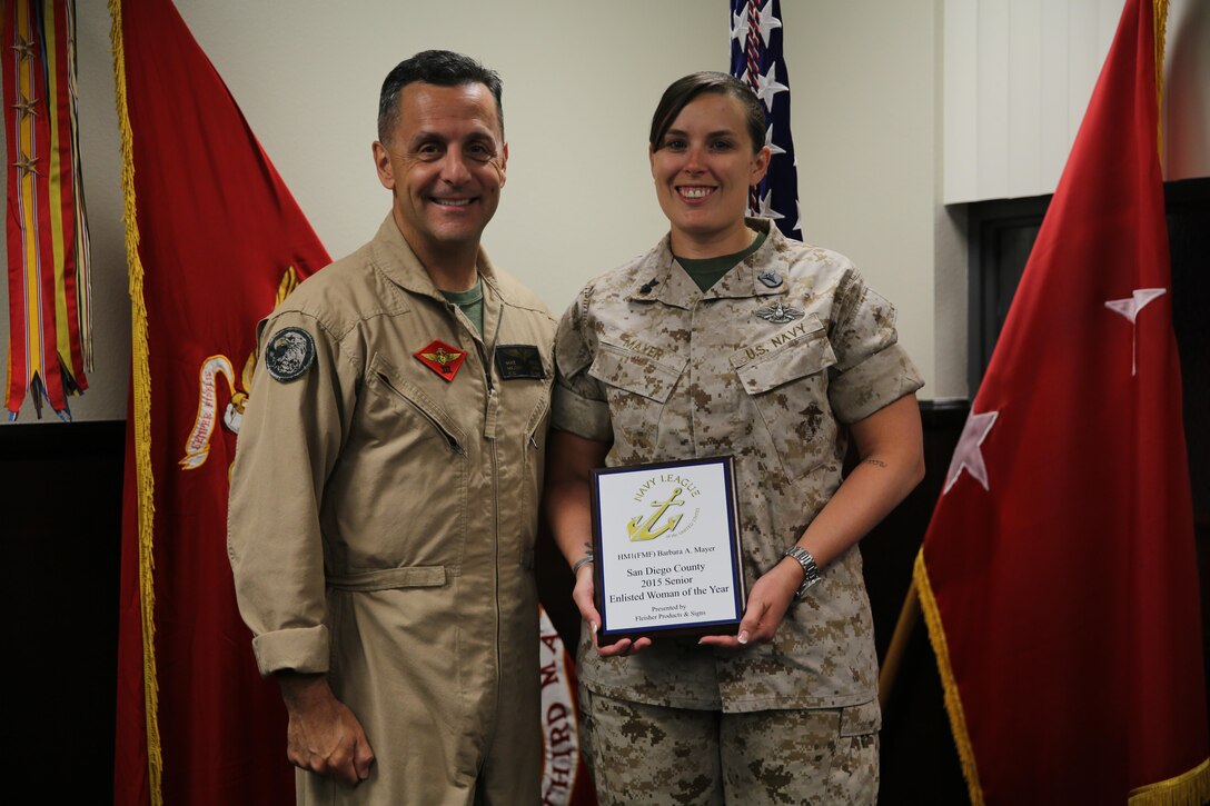 Petty Officer 1st Class Barbara Mayer, a corpsman formerly with Marine Medium Tiltrotor Squadron (VMM) 364, stands with Maj. Gen. Michael Rocco, commanding general of 3rd Marine Aircraft Wing, after recently receiving the Senior Enlisted Women of the Year award aboard Marine Corps Air Station Miramar, Calif., March 31. She was one of two 3rd Marine Aircraft Wing Sailors to receive the award this year.