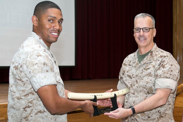 Chief Petty Officer Fred C. Turner, left, presents Col. Dave Krebs, right, with an award recognizing the 1st Marine Aircraft Wing as one of the two units that raised the most money for last year’s Navy-Marine Corps Relief Society Active Duty Fund Drive March 16 at the Camp Foster Community Center. The NMCRS provides financial relief to active duty and retired Marines and sailors as well as their eligible surviving family members through interest-free loans and grants. A large portion of those loans and grants are raised through the ADFD, which gives active duty military a chance to donate and help their fellow service members in need. Turner is the co-coordinator for the Okinawa NMCRS ADFD, and Krebs is the chief of staff for 1st MAW, III Marine Expeditionary Force. 