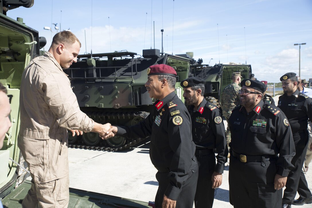 Saudi Arabian Marine Corps officers meet  with Cpl. Robert Loeffler, the assistance maintenance chief at Marine Corps Training Center in Tampa, Fla., Dec. 5, 2014. The Saudi Arabian Marine Corps officers visited Marines with 4th AA Bn. to attend a demonstration about the capabilities of amphibian assault vehicles.