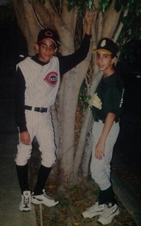Anibal and Leonel DeJesus-Martinez pose after a baseball game as teenagers. The brothers used their competitiveness to push each other to be the best in sports as kids and now as F-22 Raptor integrated avionics technicians in the Air Force. (Courtesy photo)