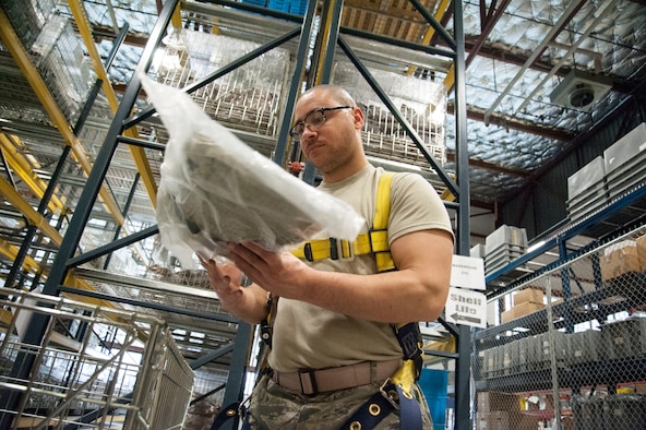 Staff Sgt. Micheal Heger, 92nd Logistics Readiness Squadron individual protective equipment supervisor, counts uniform items during inventories March 26, 2015, at Fairchild Air Force Base, Wash. The material management flight conducts inventory by pulling assets off the shelf and verifying the identity of the asset, the physical quantity and then matching the count in the computer database. (U.S. Air Force photo/Staff Sgt. Samantha Krolikowski)