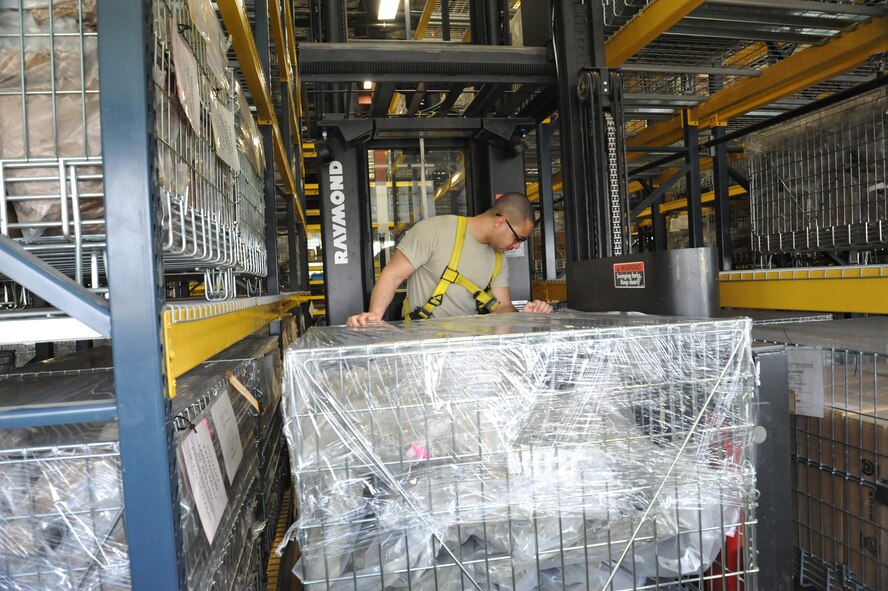 Staff Sgt. Micheal Heger, 92nd Logistics Readiness Squadron individual protective equipment supervisor, backs up a Raymond 3K stock picker with supplies March 26, 2015, at Fairchild Air Force Base,Wash. The material management flight maintains supplies of gear to fulfill deployment requirements, training, and equipping fliers and security forces with the protective equipment needed to accomplish their missions. (U.S. Air Force photo/Staff Sgt. Samantha Krolikowski)