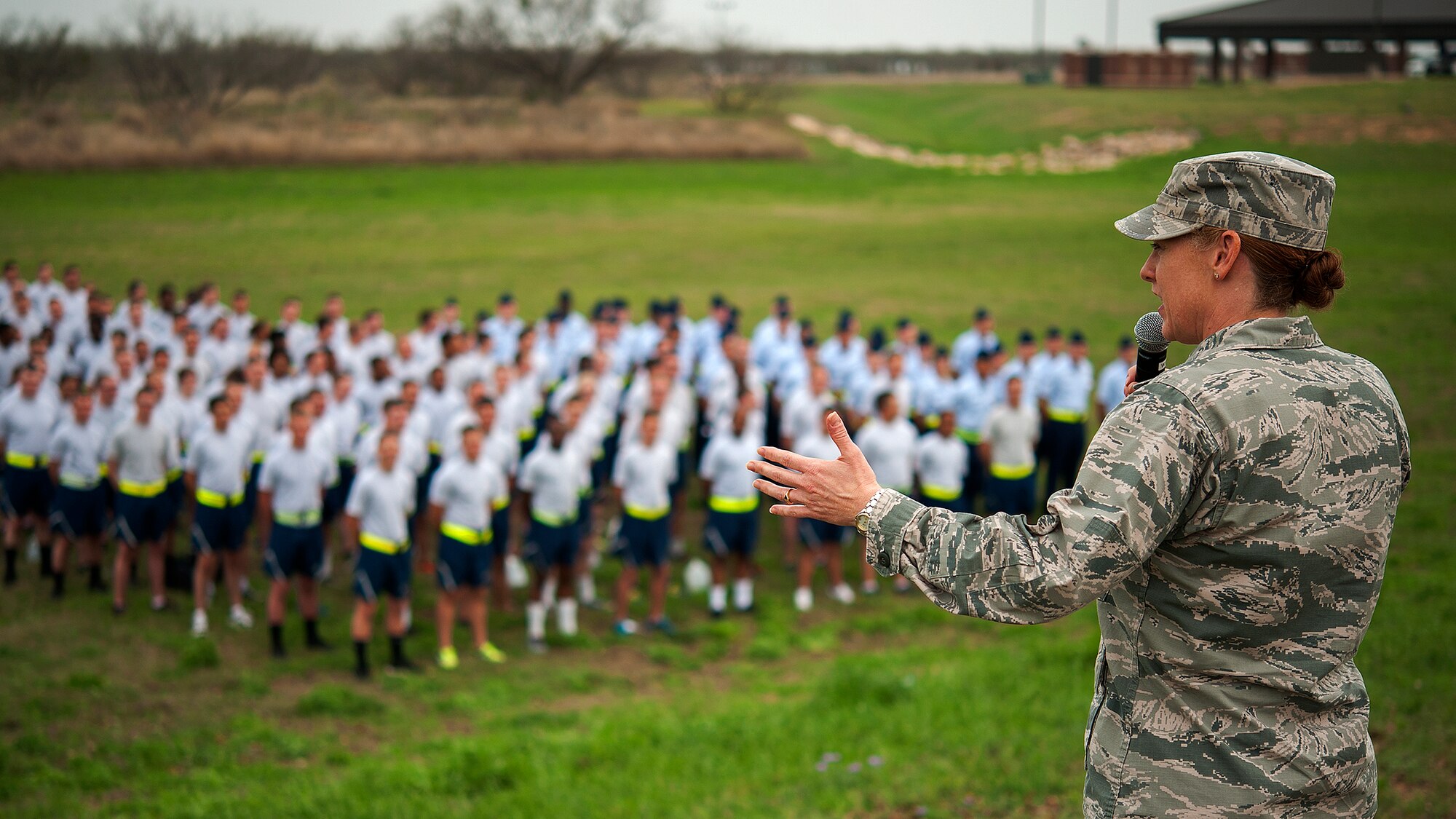 GOODFELLOW AIR FORCE BASE, Texas – Col. Kimberlee P. Joos, 17th Training Wing Commander, addresses students in a field during the Spring Wing Ding March 31. After Joos’ speech, she released the students so they could participate in morale events. (U.S. Air Force photo/ Airman 1st Class Devin Boyer)