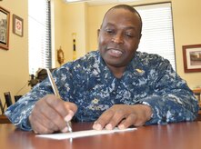 Naval Health Clinic Charleston Commanding Officer Capt. Marvin Jones signs a donation form for the Navy and Marine Relief Corps Society fund drive March 25, 2015 at the clinic. NMCRS was established in 1904 to aid Sailors and Marines in urgent financial need. Through donations, the Navy-marine Corps Relief Society may be able to provide an interest-free loan or grant. In an emergency, the Society can provide assistance for basic living needs, such as food, rent, and utilities; essential vehicle repairs; emergency travel;
disaster relief and funeral assistance. The Society also has caseworkers to provide financial counseling to help service members plan for better financial stability. Visit www.nmcrs.org for more information. (U.S. Navy photo / Kris Patterson)