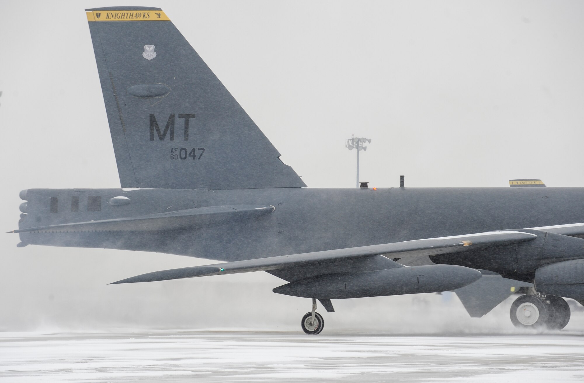 Snow kicks up behind a B-52H Stratofortress during a rapid launch exercise on Minot Air Force Base, N.D., March 27, 2015. The base conducts exercises in a variety of weather conditions to test the response capabilities of both aircrew and ground personnel. (U.S. Air Force photo/Senior Airman Stephanie Morris)