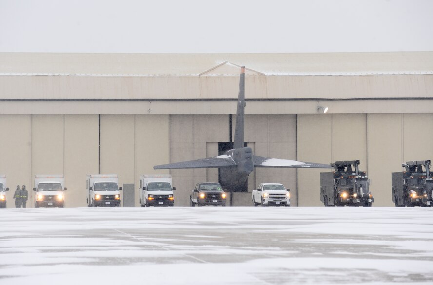 Maintenance vehicles sit in a row on the flightline during a rapid launch exercise on Minot Air Force Base, N.D., March 27, 2015. Maintenance Airmen worked side-by-side with fire department and security forces personnel to ensure the exercise was a success. (U.S. Air Force photo/Senior Airman Stephanie Morris)
