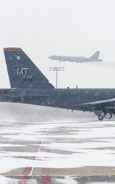 The 5th Bomb Wing’s “flag ship” B-52H Stratofortress taxis into position as another B-52 takes off during a rapid launch exercise on Minot Air Force Base, N.D., March 27, 2015. During the exercise, several B-52s took off in rapid succession. (U.S. Air Force photo/Senior Airman Stephanie Morris)