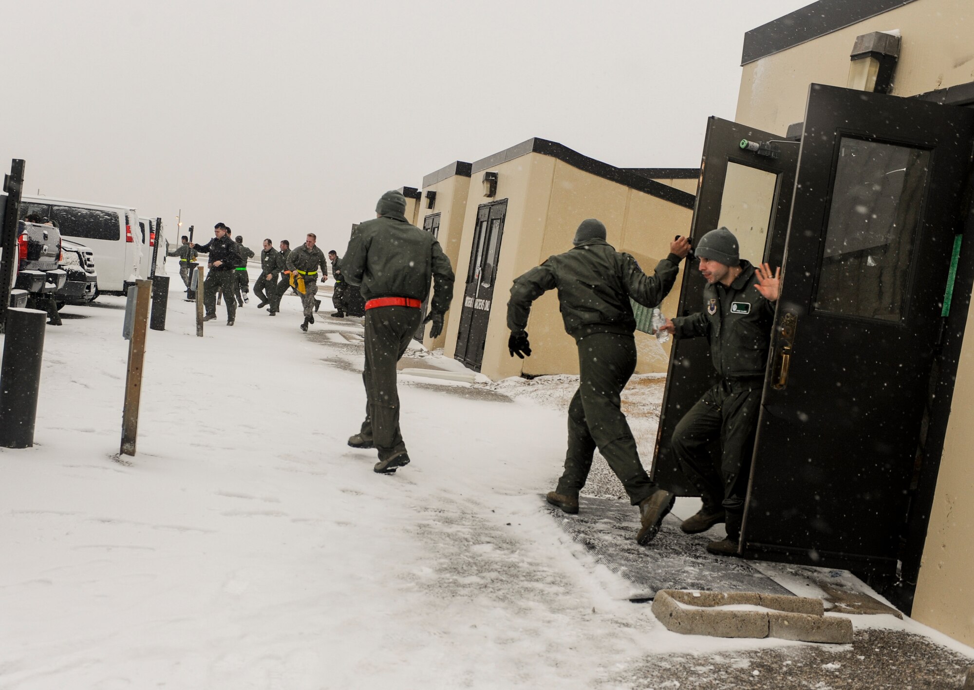 B-52H Stratofortress crew members run from the alert facility to their vehicles during a rapid launch exercise on Minot Air Force Base, N.D., March 27, 2015. The exercise tested the crew’s responsiveness and their ability to rapidly and effectively get their planes airborne. (U.S. Air Force photo/Senior Airman Stephanie Morris)