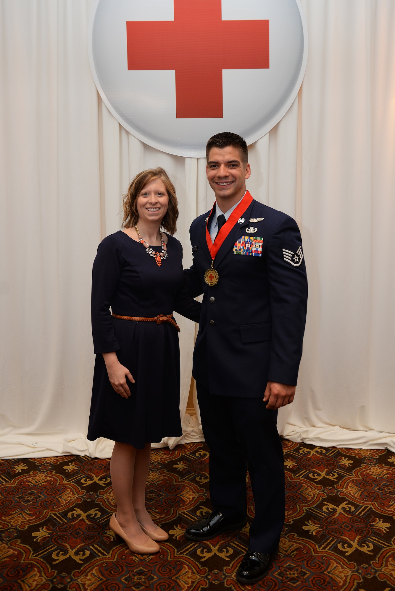 Staff Sgt. Andrew Drysdale, 375th Civil Engineer Squadron Explosive Ordnance Disposal Team Leader, was recognized for his selfless leadership during a local emergency at the 2015 American Red Cross Heroes Breakfast and stands with his wife Nicki, St. Louis, Missouri, March 26, 2015. He headed the assistance efforts after an explosion at a Granite City, Illinois recycling center that killed two employees and helped ensure that the area was safe and the hazardous materials were disposed of properly. (U.S. Air Force photo by Airman 1st Class Erica Crossen)