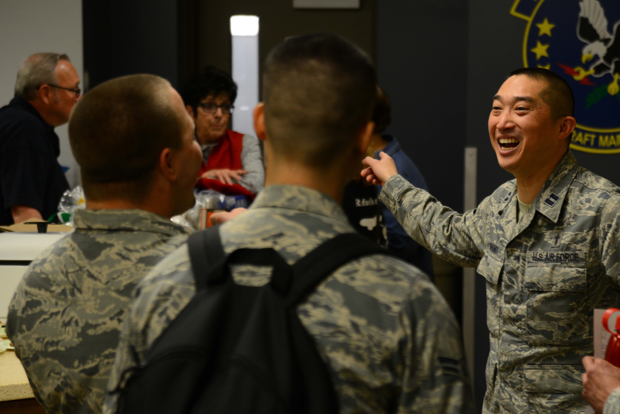 Chaplain (Capt.) Asa Chung, 22nd Air Refueling Wing protestant chaplain, speaks with Airmen from the 22nd Aircraft Maintenance Squadron, March 26, 2015, at McConnell Air Force Base. Chung and volunteers from the chapel, held a chili lunch to motivate the Airmen and to make them more comfortable when they need to approach a chaplain. (U.S. Air Force photo by Airman 1st Class Christopher Thornbury)