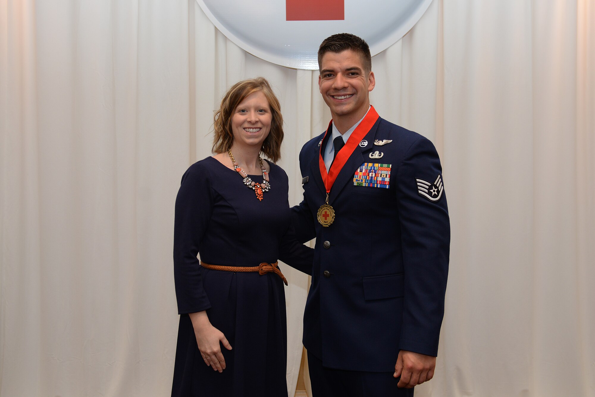Staff Sgt. Andrew Drysdale, 375th Civil Engineer Squadron Explosive Ordnance Disposal Team Leader, was recognized for his selfless leadership during a local emergency at the 2015 American Red Cross Heroes Breakfast and stands with his wife Nicki, St. Louis, Missouri, March 26, 2015. He headed the assistance efforts after an explosion at a Granite City, Illinois recycling center that killed two employees and helped ensure that the area was safe and the hazardous materials were disposed of properly. (U.S. Air Force photo by Airman 1st Class Erica Crossen)