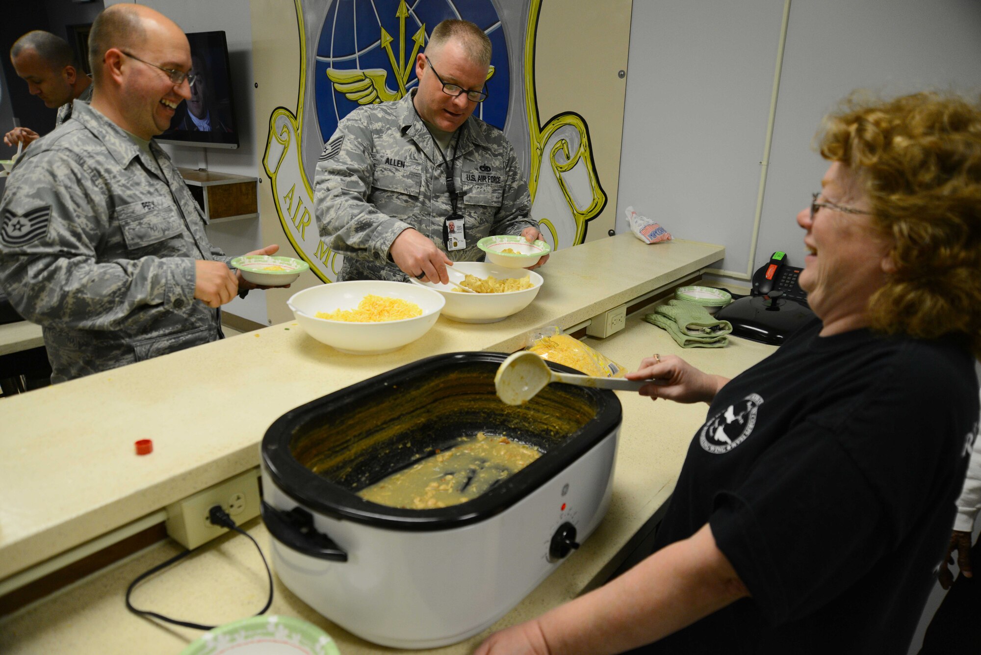 A volunteer serves a bowl of chicken chili during a chili lunch March 26, 2015, at McConnell Air Force Base, Kan. The McConnell Chapel sponsored the lunch to help boost morale and build bridges for the 22nd Aircraft Maintenace Squadron Airmen. (U.S. Air Force photo by Airman 1st Class Christopher Thornbury)