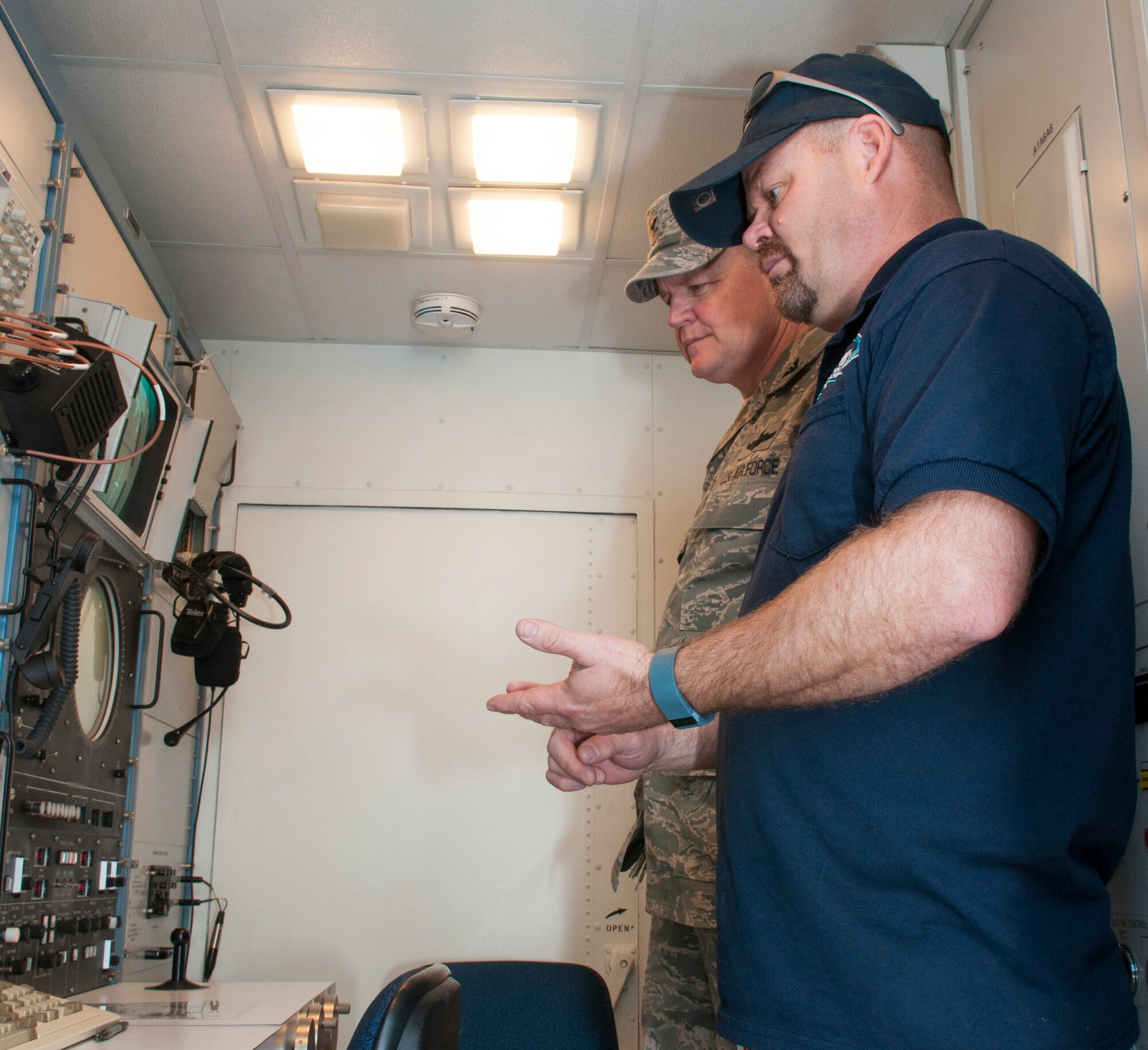 U.S. Air Force 307th Bomb Wing Commander, Colonel Bruce Cox, listens to a civilian contractor describes the features of a newly installed Multiple Threat Emitting System (MUTES) while touring Claiborne Range in Louisiana on March 25, 2015. The MUTES will provide real time Electronic Countermeasure training for aircrews. (U.S. Air Force photo by Master Sgt. Dachelle Melville/Released)
