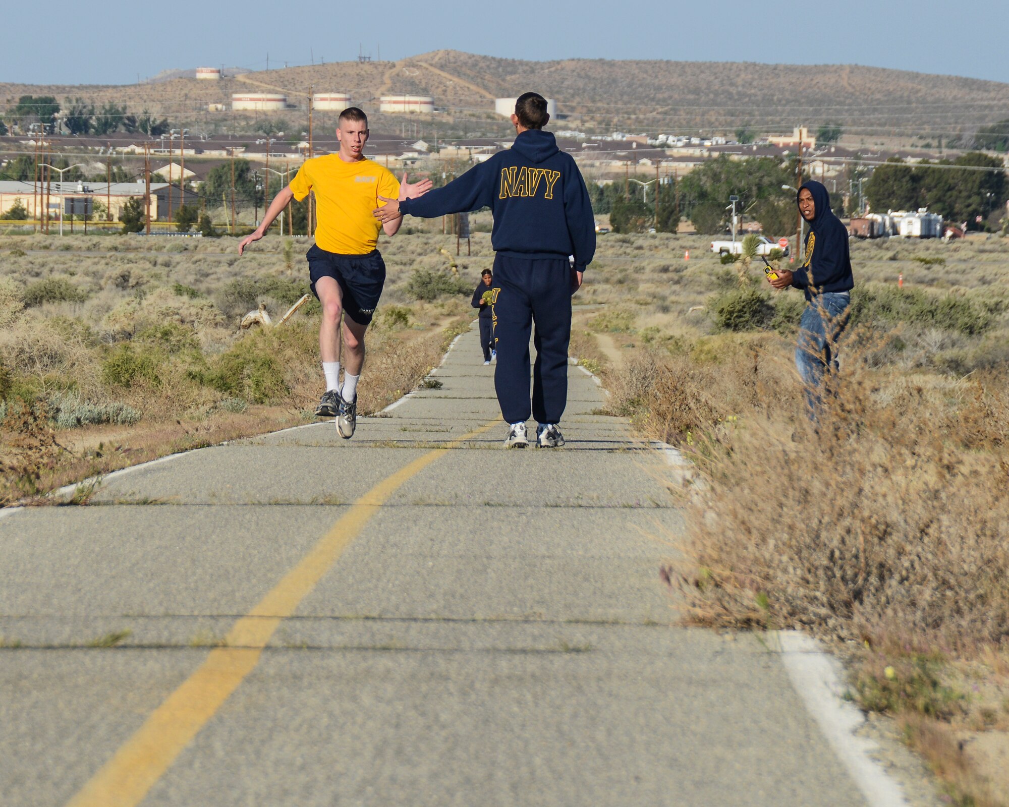 Seaman Christopher Chapman was the second runner back with Petty Officer 2nd Class Veronica Calhoun following close behind. (U.S. Air Force photo by Rebecca Amber)