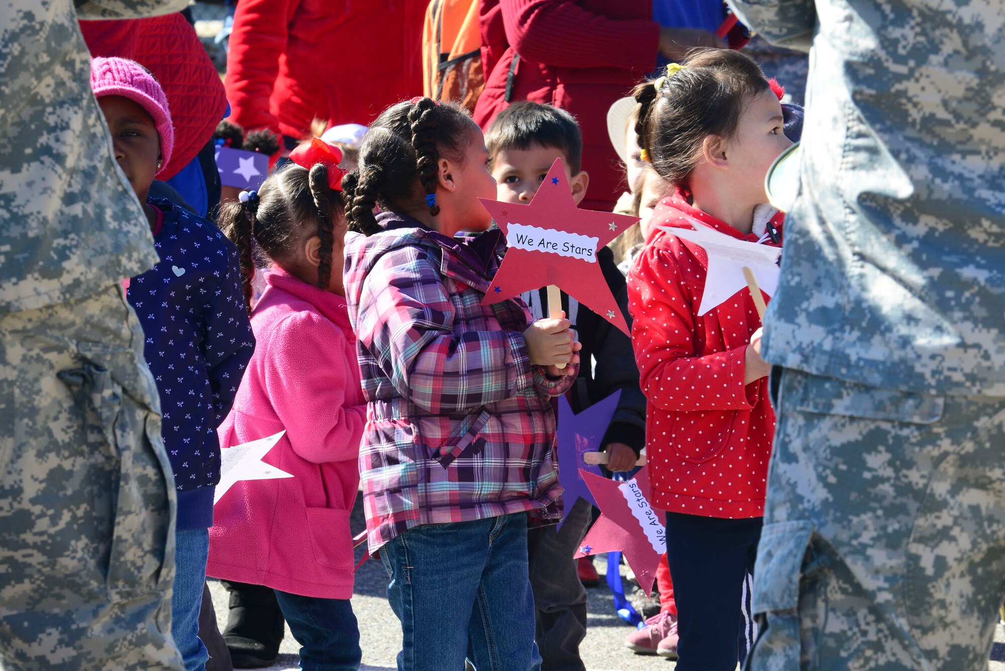 Children from the Pershing Child Development Center take part in a parade celebrating the Month of the Military Child at Fort Eustis, Va., April 1, 2015. During the parade, children were accompanied by personnel from the U.S. Army Training and Doctrine Command Band as they paraded around the buildings’ parking lot. (U.S. Air Force photo by Senior Airman Kimberly Nagle/Released)