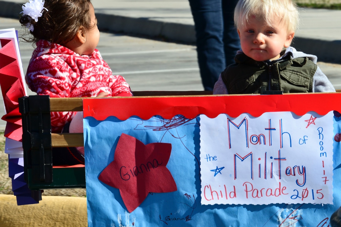 Children from the Pershing Child Development Center show off a sign during a parade celebrating the Month of the Military Child at Fort Eustis, Va., April 1, 2015. Joint Base Langley-Eustis will host a number of events throughout the month including a teen lock-in and a parents’ night out. (U.S. Air Force photo by Senior Airman Kimberly Nagle/Released)