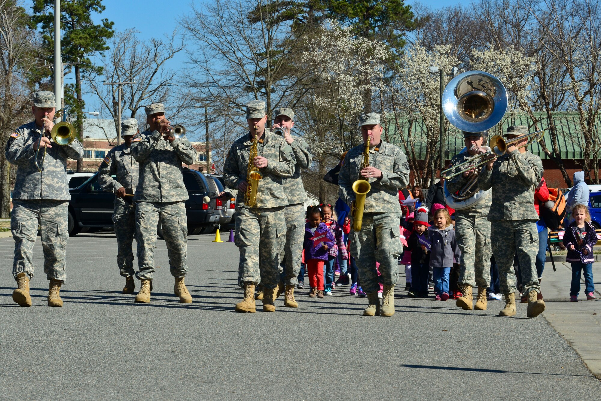 Children from the Pershing Child Development Center and members of the U.S. Army Training and Doctrine Command Band participate in a parade celebrating Month of the Military Child at Fort Eustis, Va., April 1, 2015. The celebration is used to raise awareness of the stressors and life changes affecting children of U.S. Service members. (U.S. Air Force Photo by Senior Airman Kimberly Nagle/Released)