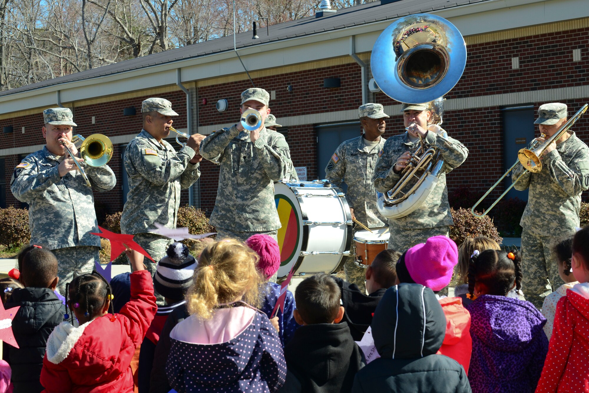 The U.S. Army Training and Doctrine Command Band play for children from the Pershing Child Development Center before a parade celebrating Month of the Military Child at Fort Eustis, Va., April 1, 2015. According to the National Child Traumatic Stress Network, most military children are healthy and resilient, and may have positive outcomes as a result of certain deployment stressors, some groups are more at risk. (U.S. Air Force photo by Senior Airman Kimberly Nagle/Released)