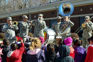 The U.S. Army Training and Doctrine Command Band play for children from the Pershing Child Development Center before a parade celebrating Month of the Military Child at Fort Eustis, Va., April 1, 2015. According to the National Child Traumatic Stress Network, most military children are healthy and resilient, and may have positive outcomes as a result of certain deployment stressors, some groups are more at risk. (U.S. Air Force photo by Senior Airman Kimberly Nagle/Released)