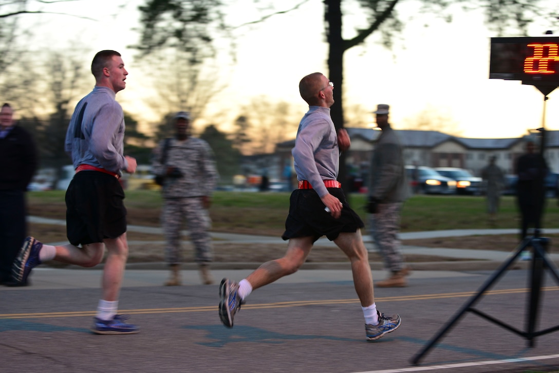 U.S. Army Soldiers cross the finish line during the Sexual Assault Awareness and Prevention Month 5K run at Fort Eustis, Va., April 1, 2015. The run was hosted by the 7th Transportation Brigade (Expeditionary) and open to all installation personnel to help kick off SAAPM. (U.S. Air Force photo by Senior Airman Kimberly Nagle/Released)
