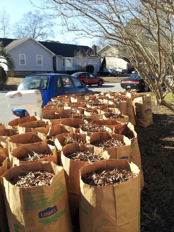 A team of Airmen from Joint Base Charleston, S.C., volunteered over the Martin Luther King Jr., holiday to clean up the yard of Scott and Tina Fox, who are friends of Valerie Singley, 17th Airlift Squadron unit training manager. In September 2014 Scott was diagnosed with cancer and following treatment and surgery, his wife Tina had become his full time caregiver, leaving no time to work in the yard. After three and-a-half hours of yard work, the Airmen had bagged 50 bags of yard clippings, removed branches from the roof of the house and organized the Fox’s garage. (Courtesy photo) 