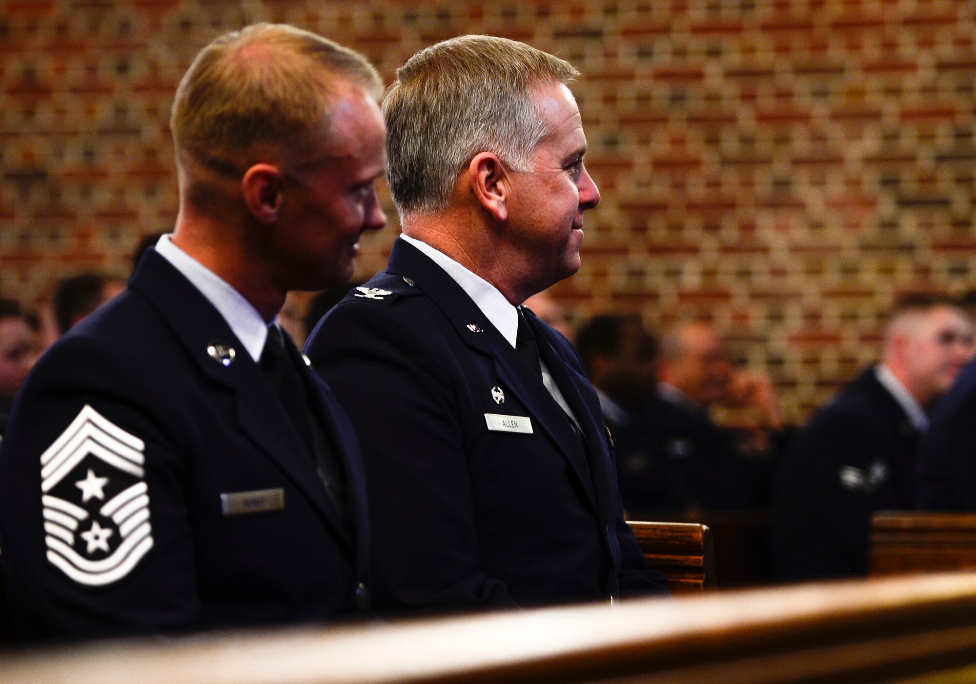 U.S. Air Force Col. John J. Allen Jr., 633rd Air Base Wing commander, and Chief Master Sgt. Mark Hurst, 633rd ABW command chief, attend a memorial service for Airman 1st Class Zachary Wolfe at Langley Air Force Base, Va., March 24, 2015. Wolfe was a member of the 633rd Logistics Readiness Squadron and passed away March 17, 2015. (U.S. Air Force photo by Senior Airman Kayla Newman/Released)