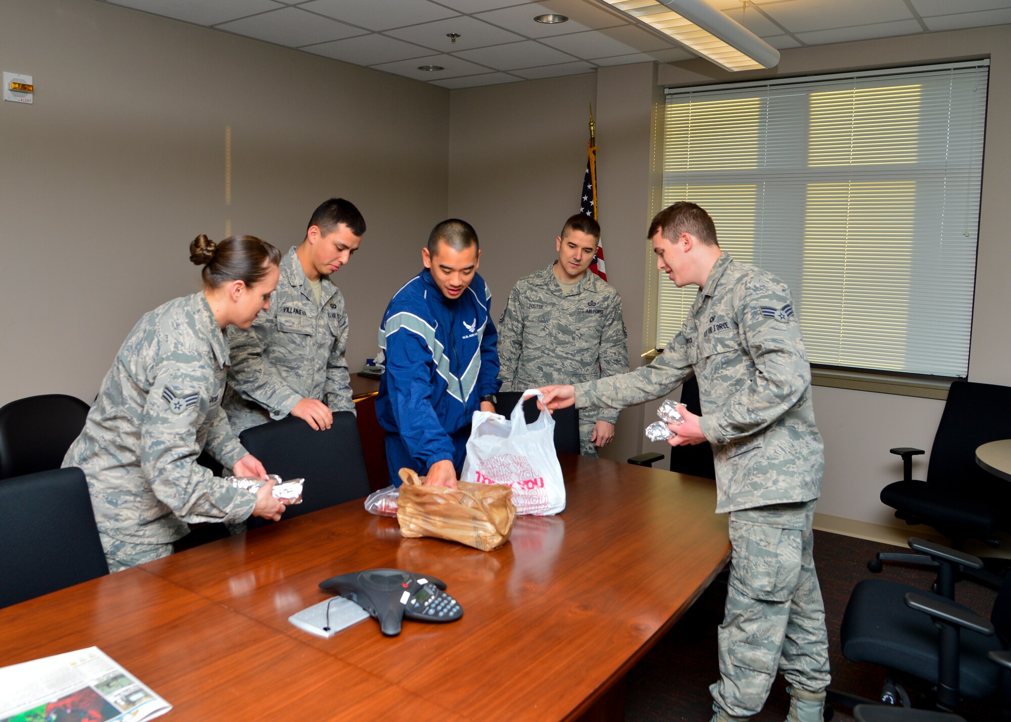 Airmen from the 436th Operations Support Squadron Aircrew Flight Equipment Flight receive free breakfast burritos April 1, 2015, at Dover Air Force Base, Del. Volunteers from the Dover AFB Top 3 organization gave away more than 900 breakfast burritos to Airmen in the ranks of E-4 and below to boost morale. (U.S. Air Force photo/Airman 1st Class William Johnson)