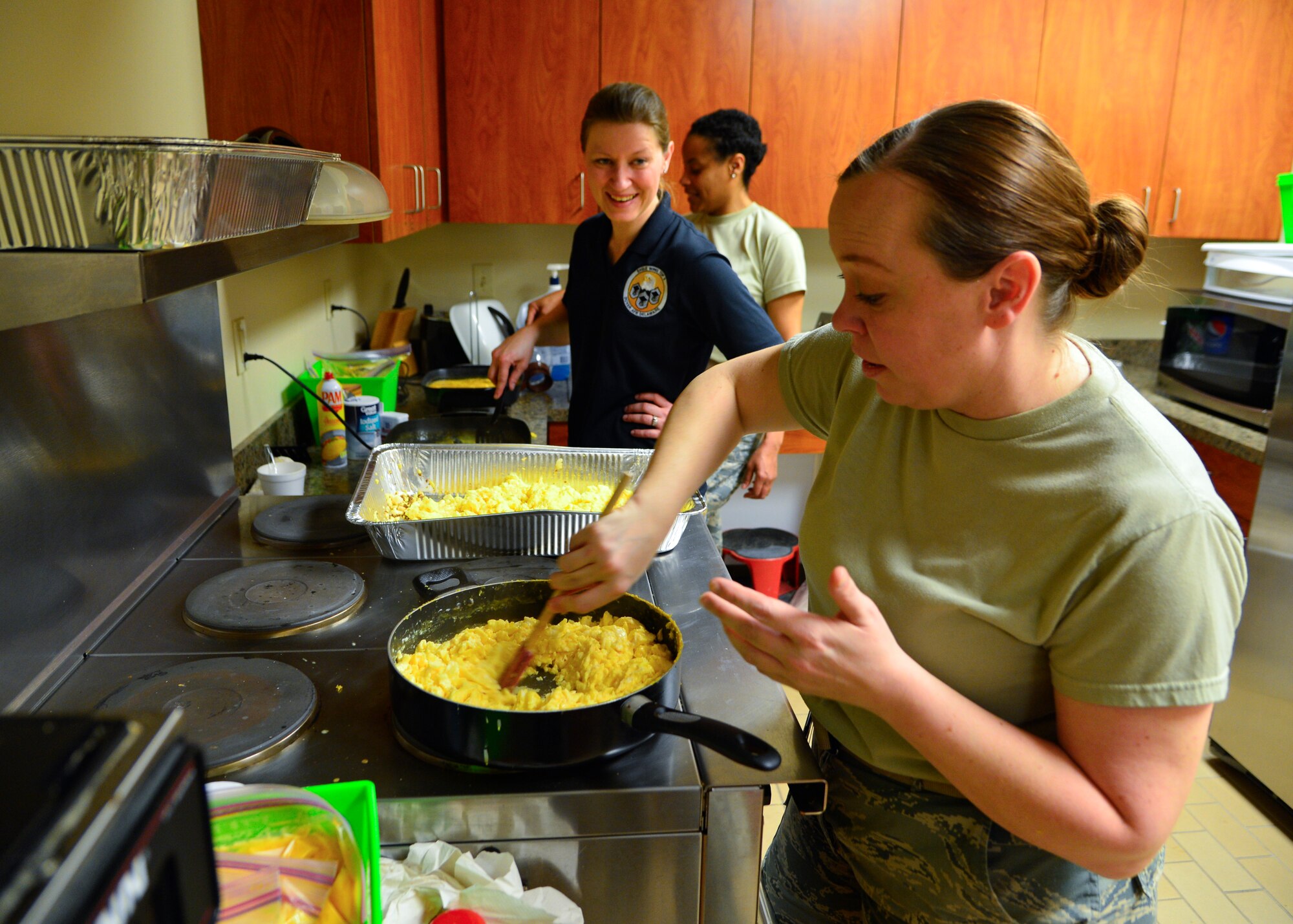Master Sgt. Star Hoffland, Air Force Mortuary Affairs Operations readiness NCO in charge, makes fresh eggs for breakfast burritos April 1, 2015, at Dover Air Force Base, Del. Volunteers from the Top 3 organization prepared more than 900 homemade breakfast burritos to distribute to Airmen in the ranks of E-4 and below to boost morale across the base. (U.S. Air Force photo/Airman 1st Class William Johnson)
