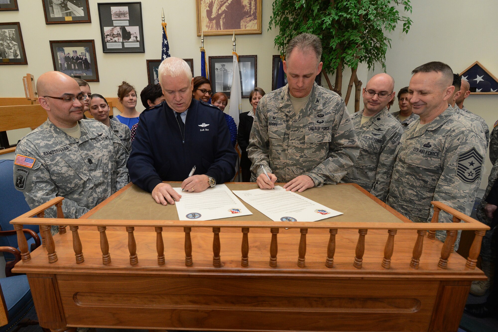 Maj. Gen. L. Scott Rice, Massachusetts National Guard Adjutant General, and Col. Michael A. Vogel, 66th Air Base Group commander, sign a joint proclamation designating April as Sexual Assault Awareness and Prevention Month on base, while Hanscom Command Chief Master Sgt. Craig A. Poling and Mass. National Guard State Command Sgt. Maj. Carlos Ramos Rivera and others watch during a ceremony in the General George Brown Building, April 1. The proclamation encourages everyone to “know what sexual violence is, how to prevent it, how to support survivors and connect with services and how every aspect of our society can work together to better address sexual violence.” (U.S. Air Force photo by Jerry Saslav)