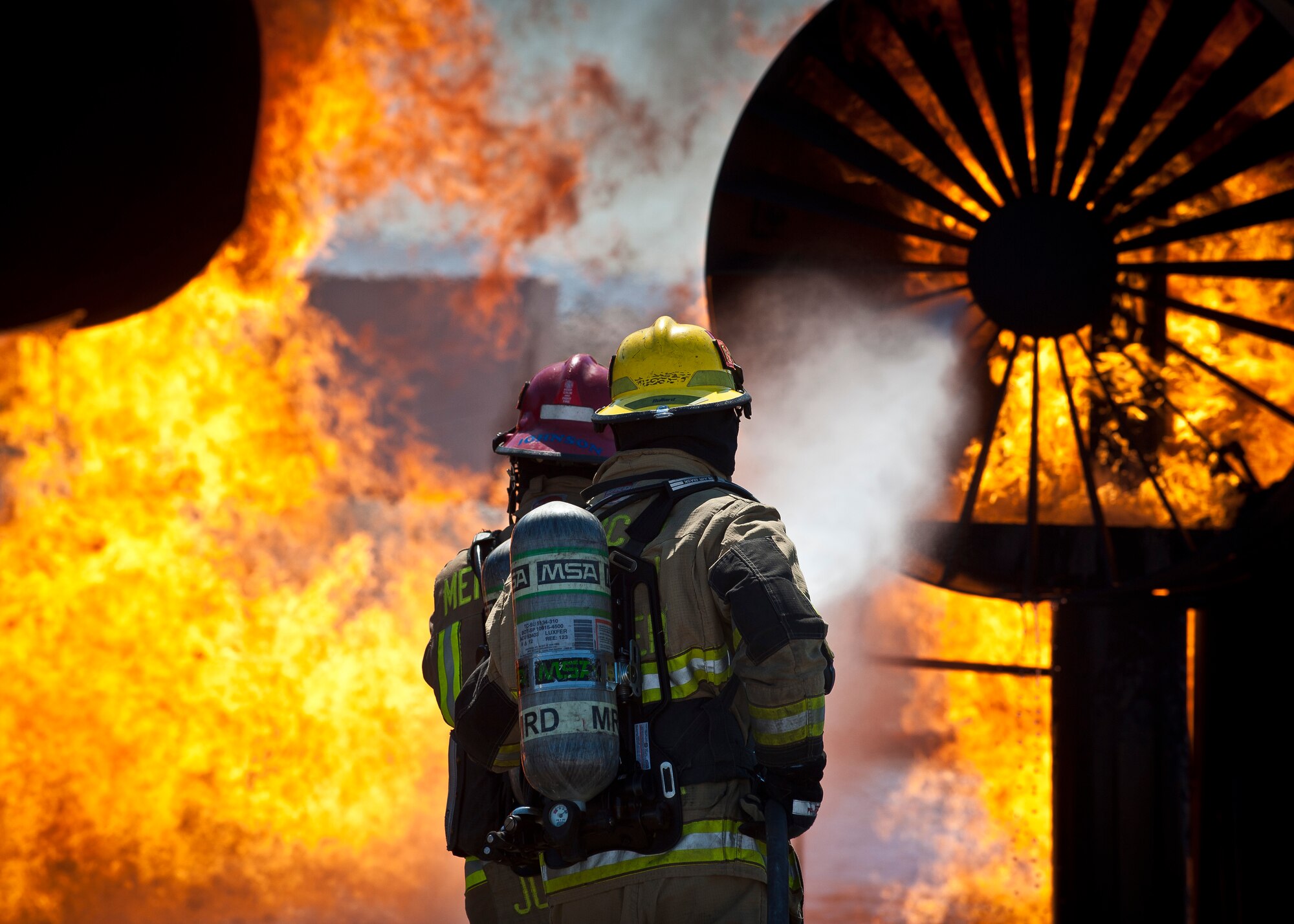 Firefighters from the Merced County Fire Department’s Castle Fire Station 62, Atwater, Calif., extinguish an aircraft fire during training at the burn pit on Nellis Air Force Base, Nev., March 27, 2015. The MCFD is responsible for responding to fires at Castle Airport, which was formerly Castle AFB, and trains at Nellis AFB every year to meet Federal Aviation Administration training requirements. (U.S. Air Force photo by Staff Sgt. Siuta B. Ika)