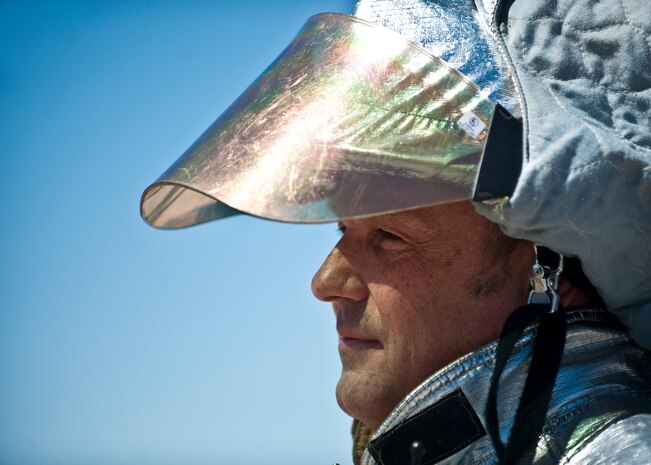 Glen Taylor, 99th Civil Engineer Squadron Fire Emergency Services Flight captain, looks on during training at the burn pit on Nellis Air Force Base, Nev., March 27, 2015. Taylor and other Nellis-Creech firefighters are required to complete aircraft fire extinguishing training at the burn pit annually to stay flightline certified and ensure their preparedness to respond rapidly to aircraft emergencies. (U.S. Air Force photo by Staff Sgt. Siuta B. Ika)